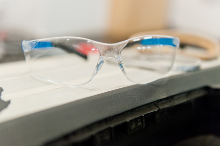 Protection glasses on a bench in work shopの写真素材