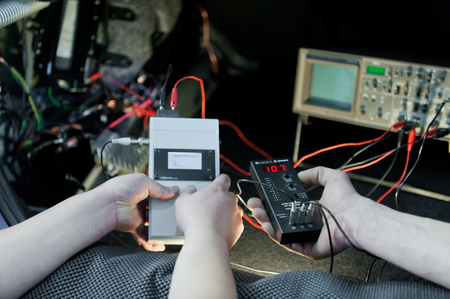 Two mechatronics working on car electricの写真素材