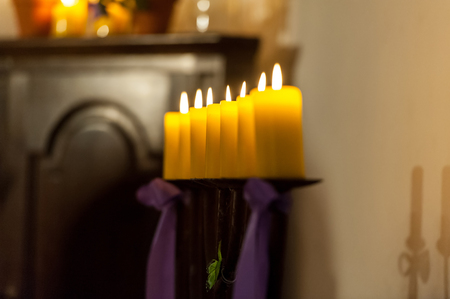 Row of yellow candles in the churchの写真素材