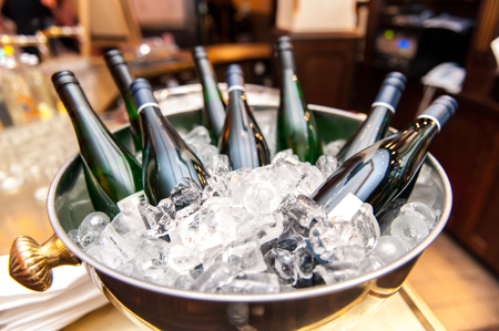 Wine bottles in ice bucketの写真素材