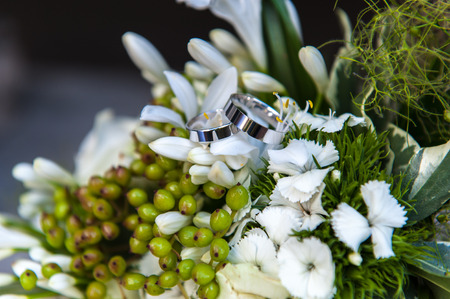 Weddings rings on flower bouquetの写真素材