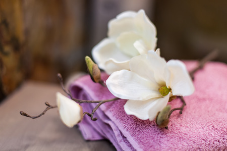 Beautiful flowers on towels in bathroomの写真素材