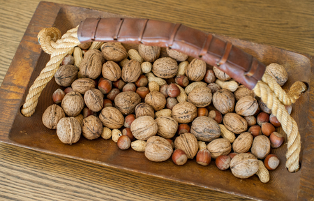 Different nuts in a wooden bowlの写真素材