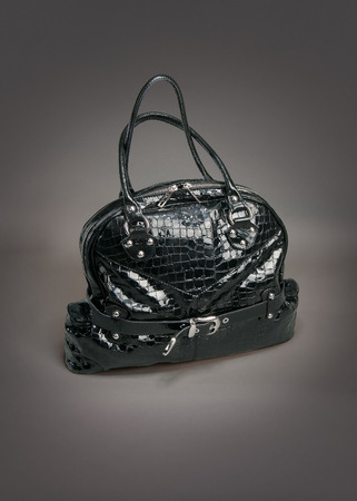 Black leather bag on gradient gray backgroundの写真素材