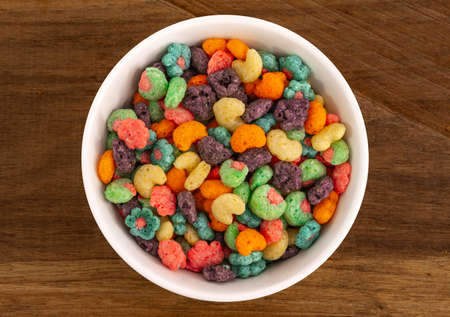 Top view of bowl with fruit cereal naturally and artificially fruit flavored sweetened corn puffs....