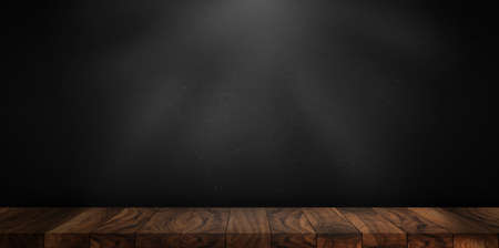 Wooden table made with natural wood planks with a concrete block wall background in a dark room, rustic environment to display artisan elements, meats or Mediterranean products.の写真素材