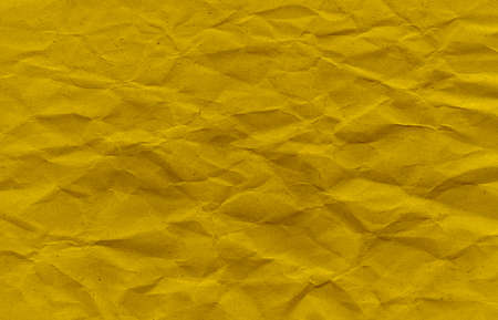 Yellow Crumpled Paper Background. Yellow rustic texture. High quality texture in extremely high resolution. Dark yellow grunge material. Texture background. Scrapbookの写真素材