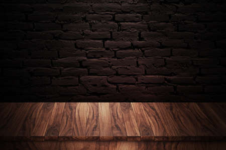 Wooden table made with natural wood planks with a concrete block wall background in a dark room, rustic environment to display artisan elements, meats or Mediterranean products.の写真素材