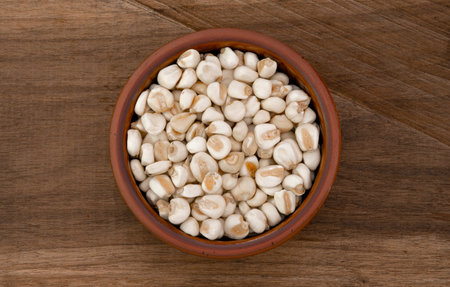 Top view of bowl with white corn for cooking on wooden table backgroundの写真素材