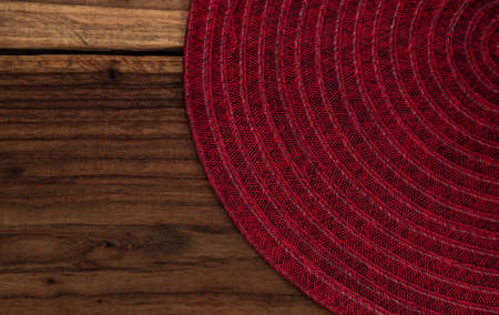 Striped kitchen towel or napkin isolated on a rustic wooden table, top view. Cloth tablecloth on woody background. Composition of elements with space to assemble artisan food. Mockupの写真素材