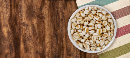 Top view of bowl with white corn for cooking on wooden table backgroundの写真素材