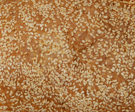 detailed view of the texture of a homemade bread, close-up shot of some sesame seeds on artisan bread.の写真素材