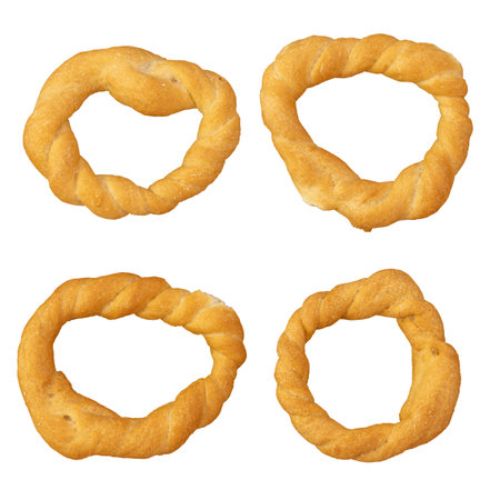 Pieces of traditional Latin American pastry called ROSQUITAS DE SAL, ROSCAS made with wheat flour. Top view of Neapolitan cookies called TARALLI. Stale salt bagels Wood table. White backgroundの写真素材