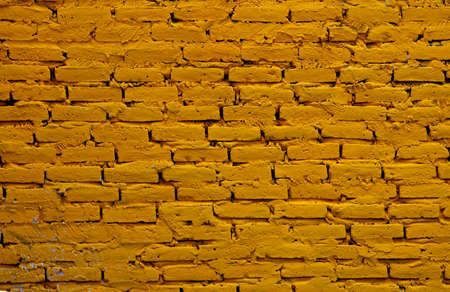 Yellow brick wall for background or textureの写真素材