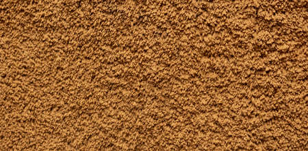 old terry cloth texture background. dark yellow color terry cotton towel close up view. Household bath towelling cloth, used towel closeup textureの写真素材