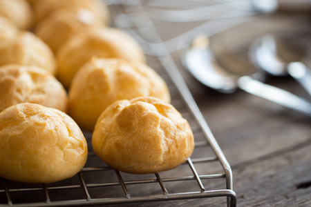 Homemade puff pastry on a cooling rack put on wood table.Selective focus.の写真素材