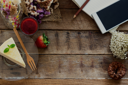 Cafe background with copy space. Crepe cake strawberry sauce on rustic wood background. Relaxing with delicious cake and use smart phone for work or entertain. Lively backgroung with copy space.の写真素材