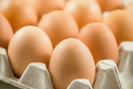 Fresh eggs in egg rack put on wood table. Prepare chicken eggs for cooking or bakery on rustic wood...