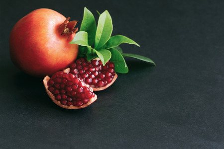 Sweet and juicy Indian pomegranate on black granite table in top view with copy space for background or wallpaper. Healthy and delicious fruit which have high vitamin c and antioxidant for good skin.の写真素材