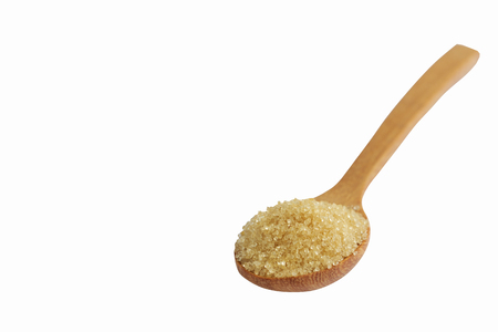 Natural brown sugar or no bleach sugar on wooden spoon on white isolated background with clipping paths in side view. Sweet seasoning for good health. Ingredient prepared for cooking or bakeryの写真素材