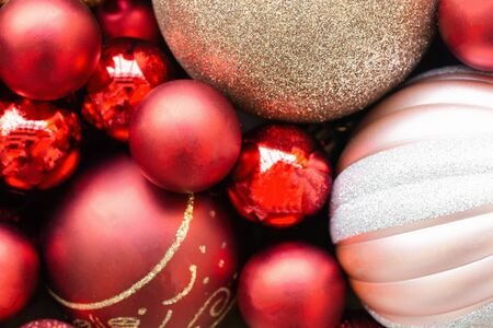 Glitter red and gold bauble Christmas ball heap in top view flat lay with copy space, close up view macro concept. Sweet and beautiful Christmas background in vintage tones for xmas wallpaper.の写真素材