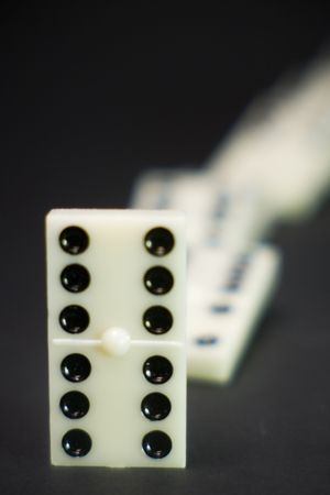 one white domino piece up other fall