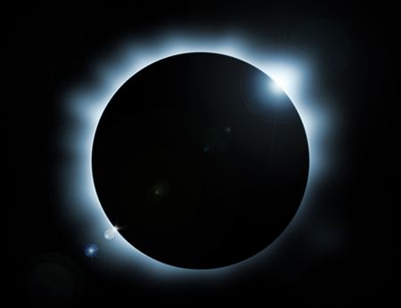 blue glow eclipse with stars in backgroundの写真素材