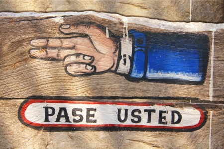 wood sign with spanish text pase usted の写真素材