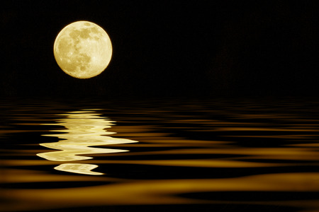 yellow moon over sea reflection