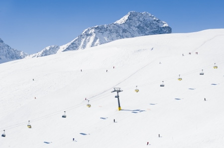 Skiers enjoying a sunny day in the mountainの写真素材