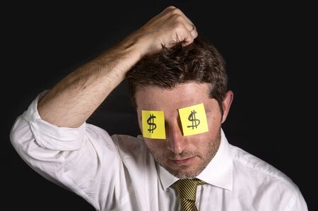 Man wearing 2 post it notes with the dollar symbol as glassesの写真素材