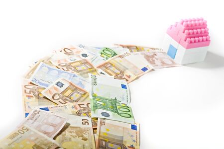 Banknotes Path to a Miniature House with Key isolated on white backgroundの写真素材