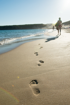 footprints in the sand at the beachの写真素材