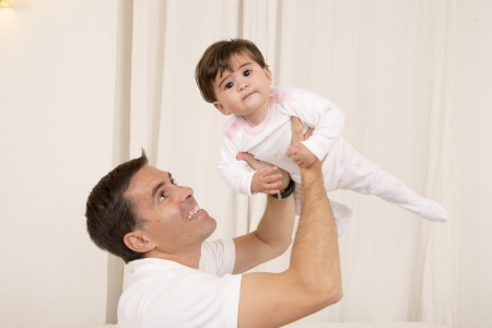Happy young father holding baby girlの写真素材