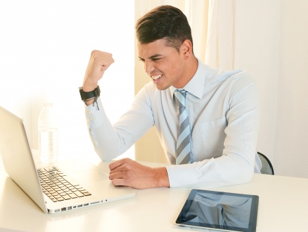 Young Successful Happy Man working at the office with Computerの写真素材