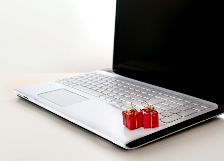 Christmas Presents on Computer Keyboard representing online shoppingの写真素材