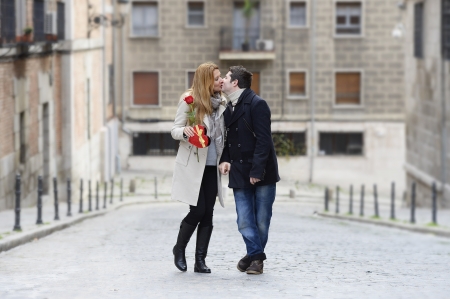 Romantic couple walking and kissing on Valentines day on urban backgroundの写真素材