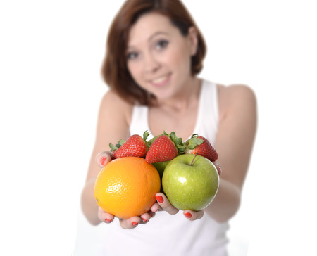 young woman carrying mix of fruit in both handsの写真素材
