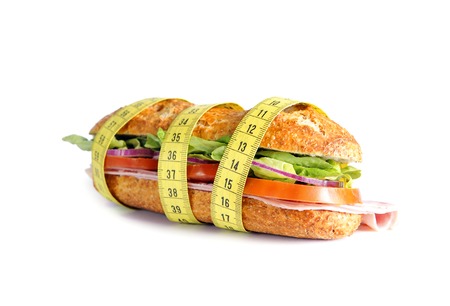 Vegetal Sandwich wrapped in measure tape in diet concept isolated on white backgroundの写真素材
