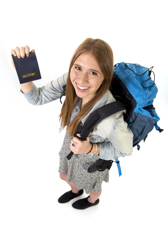 happy young student tourist woman carrying backpack showing passport in holidays trip and vacation backpacker tourism concept isolated on white backgoundの写真素材