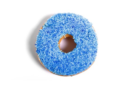 delicious and tempting donut with blue toppings isolated on white background in unhealthy nutrition and sugar and sweet cake addiction conceptの写真素材