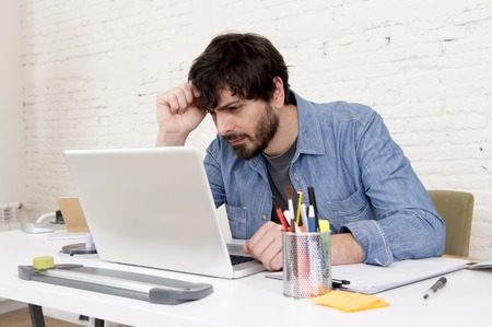 corporate portrait of young hispanic attractive hipster businessman on his 30s working at modern...