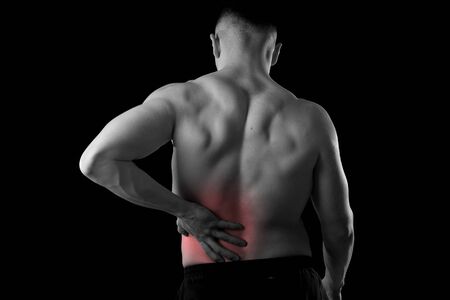 young muscular body sport man holding sore low back waist are suffering pain in athlete stress and...