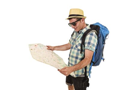 young tourist man reading city map looking relaxed and happy carrying backpack wearing summer hat and sunglasses in holiday travel adventure concept isolated white backgroundの写真素材
