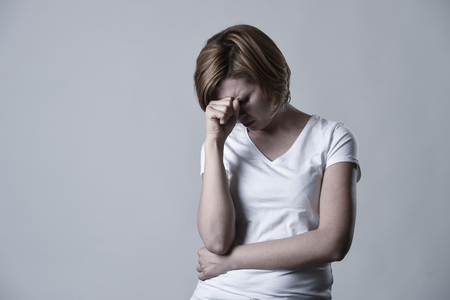 young devastated depressed woman crying sad feeling hurt suffering depression in sadness emotion gesturing helpless in pain face expression isolated background desperateの写真素材