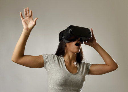 young attractive happy woman excited using 3d goggles watching 360 virtual reality vision enjoying...
