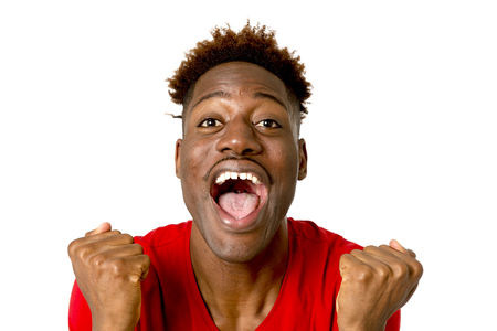young friendly and happy afro american man smiling excited and posing cool and cheerful isolated on white background having fun looking positive in intense happiness facial expressionの写真素材