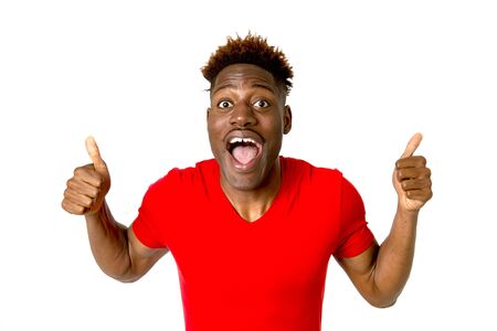 young friendly and happy afro american man smiling excited and posing cool and cheerful isolated on white background having fun looking positive in intense happiness facial expressionの写真素材