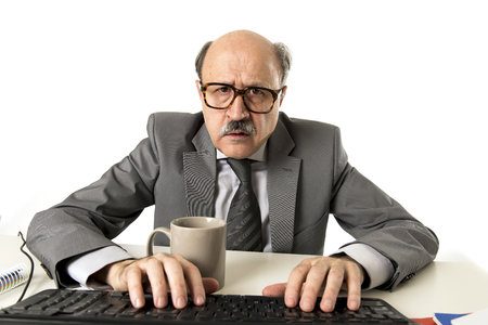 senior mature busy business man with bald head on his 60s working stressed and frustrated at office computer laptop desk looking tired and overwhelmed in job problems and overwork conceptの写真素材