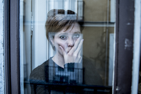 dramatic close up portrait of young beautiful woman thinking and  feeling sad suffering depression...